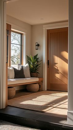 the sun shines through two windows onto a bench in front of a wooden door
