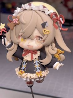 an anime figurine is posed on a stand