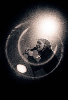 a man standing in front of a microphone on top of a stage