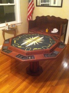 a wooden table with a star design on it in the middle of a wood floor