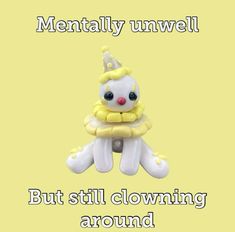 there is a small toy with a clown hat on it