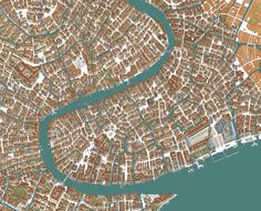 an aerial view of a city and river with brown buildings on the sides, green water in the middle