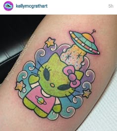 a cartoon character tattoo on the leg of a woman's thigh, with an alien spaceship above her head