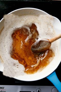 a frying pan filled with food on top of a stove