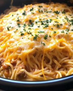 a casserole dish with meat, cheese and noodles in a crock pot