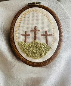 a cross is on top of a hill with grass