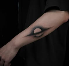a man's arm with a black and white tattoo design on the left forearm