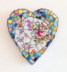 a stained glass heart with flowers on it