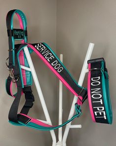 a dog harness attached to a white pole