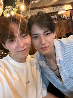 two young men sitting next to each other