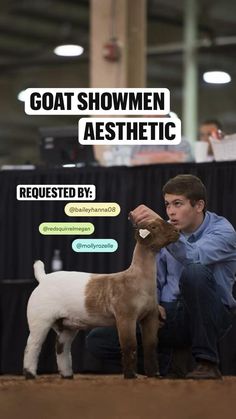 a man kneeling down petting a dog on top of a floor next to a sign that says goat showmen aesthetic