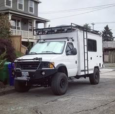 a white truck parked in front of a house