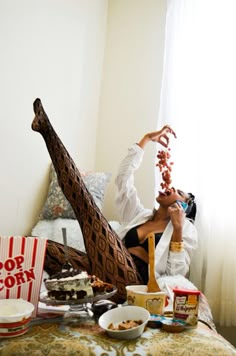 a woman sitting on top of a bed with food