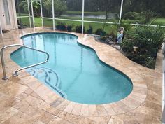 an empty swimming pool in the middle of a backyard with tiled flooring and walls