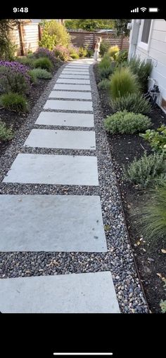 a stone walkway in front of a house