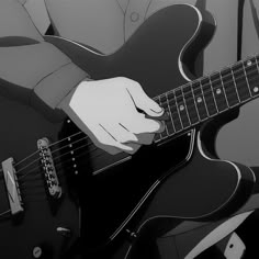 a person playing an electric guitar with their hand on the top of its neck, in black and white