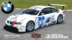 a white bmw race car driving down a track