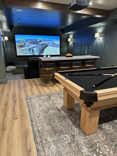 a game room with a pool table and television