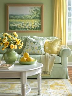 a living room with green walls and yellow flowers in the vase on the coffee table
