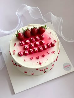 a birthday cake decorated with strawberries and the words happy birthday written in frosting
