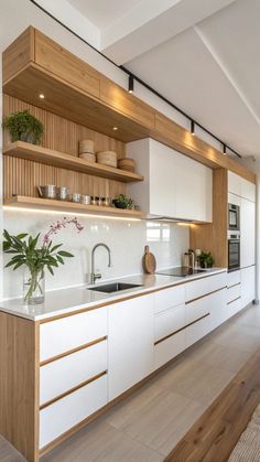 a modern kitchen with white cabinets and wood counter tops is seen in this image from the front view