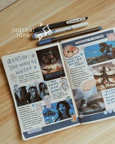 an open book with pictures and pencils next to it on top of a wooden table