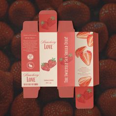 two packages with strawberries on them sitting next to each other