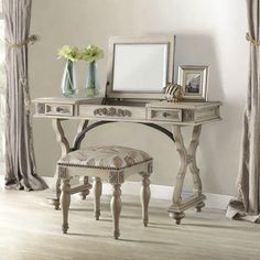 a white desk with a mirror and stool in front of it on a hard wood floor