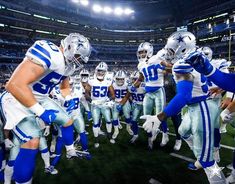a group of football players standing on top of a field