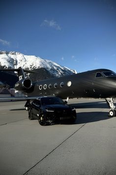 a large jetliner sitting on top of an airport tarmac next to a black car
