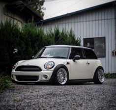 a small white car parked in front of a building