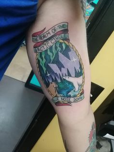 a person with a tattoo on their arm that reads, dream of the arctic circle