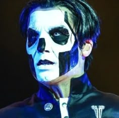 a man with black and white face paint on his face