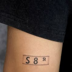 a woman with a small tattoo on her leg that reads s8e02