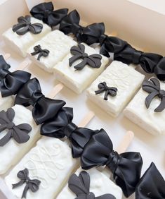 black and white lollipops with bows on them