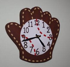 a clock that is shaped like a hand with red and white numbers on the hands