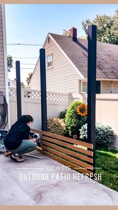 a woman kneeling down next to a wooden bench in front of a white house with the words love's outdoor patio refresh