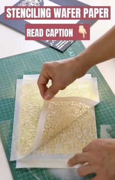 someone is cutting paper on top of a table