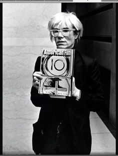 an older woman holding up a book in front of her face with the title american film 101