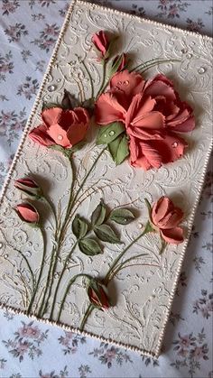 some pink flowers are on a white doily