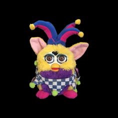 a stuffed animal with big eyes and a checkered shirt on it's chest