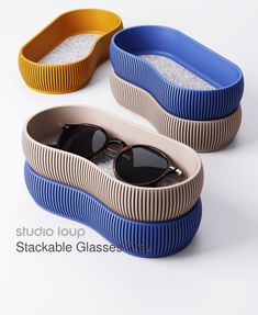 two oval shaped sunglasses sitting inside of a container