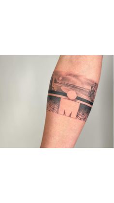 a man's arm with a black and white photo on it that has the word,
