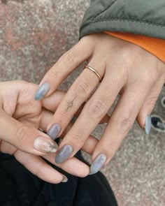 two people with manicured nails holding each other's hands