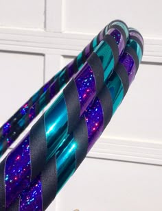 two blue and purple objects are hanging on the wall