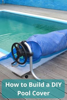 a pool cover sitting on top of a wooden deck next to a swimming pool