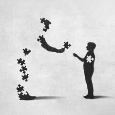 a man standing in front of a group of puzzle pieces with one holding the other's hand