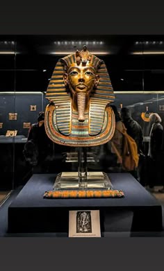 an egyptian mask on display in a museum