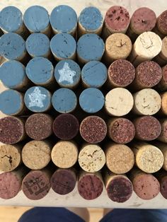 several different types of wine corks stacked on top of each other with one person standing next to them