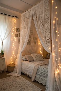 a bed with white curtains and lights on it